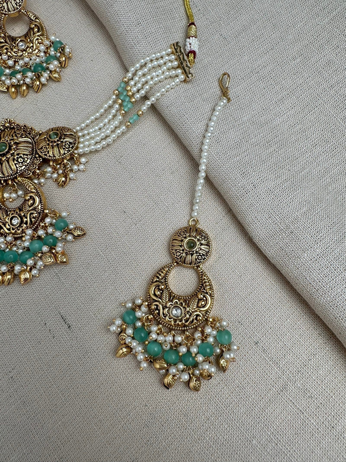 Mint Green antique gold maang tikka and matching earrings detail