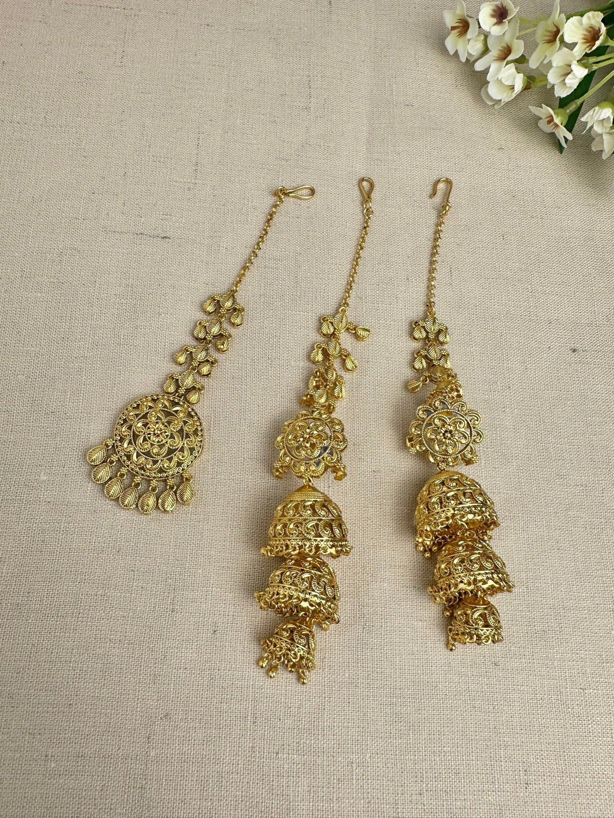 Bright yellow-gold-plated Punjabi triple jhumki earrings and matching medium tikka