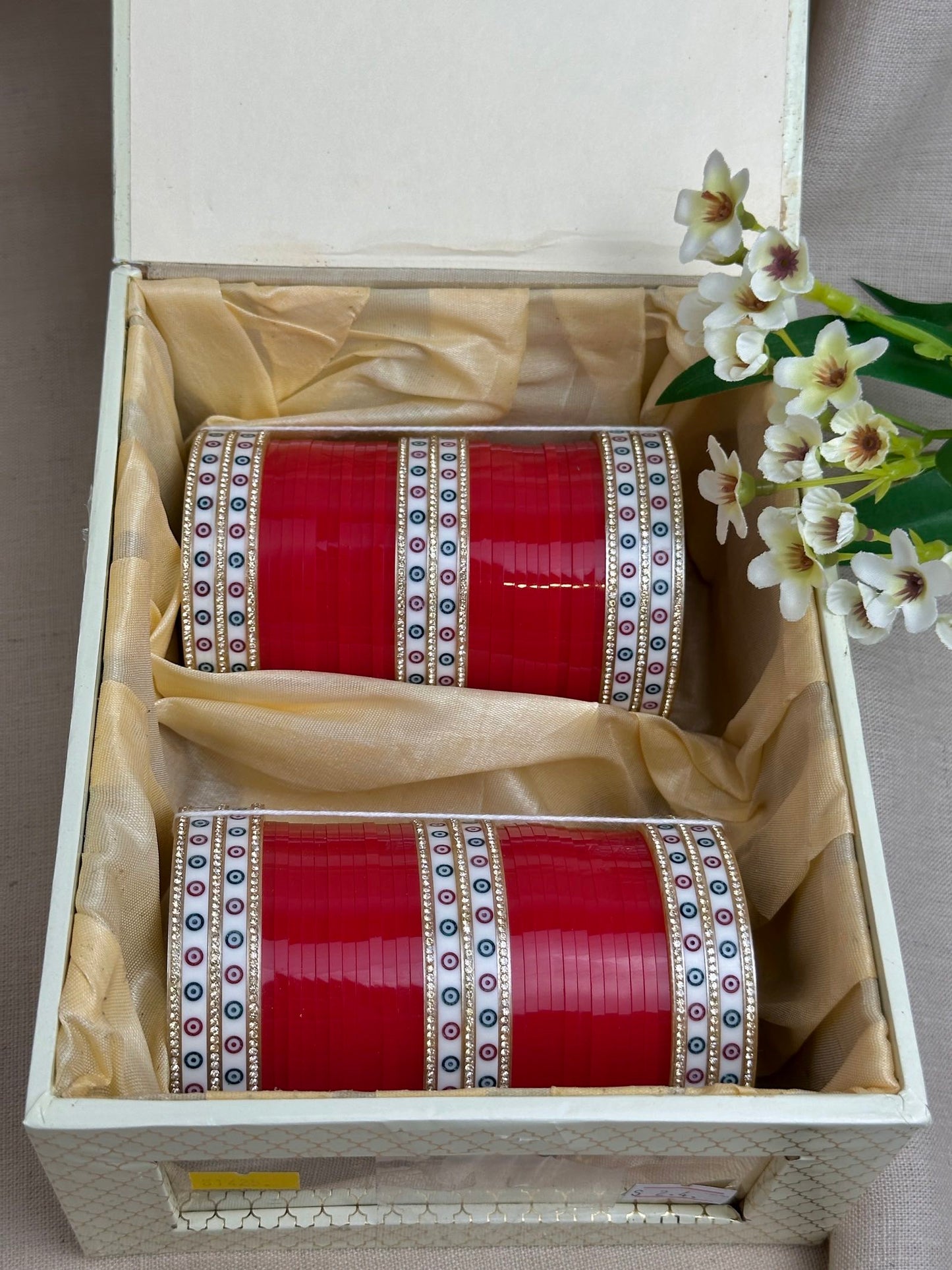 Complete red Punjabi chooda set for both arms arranged inside the included bridal box.