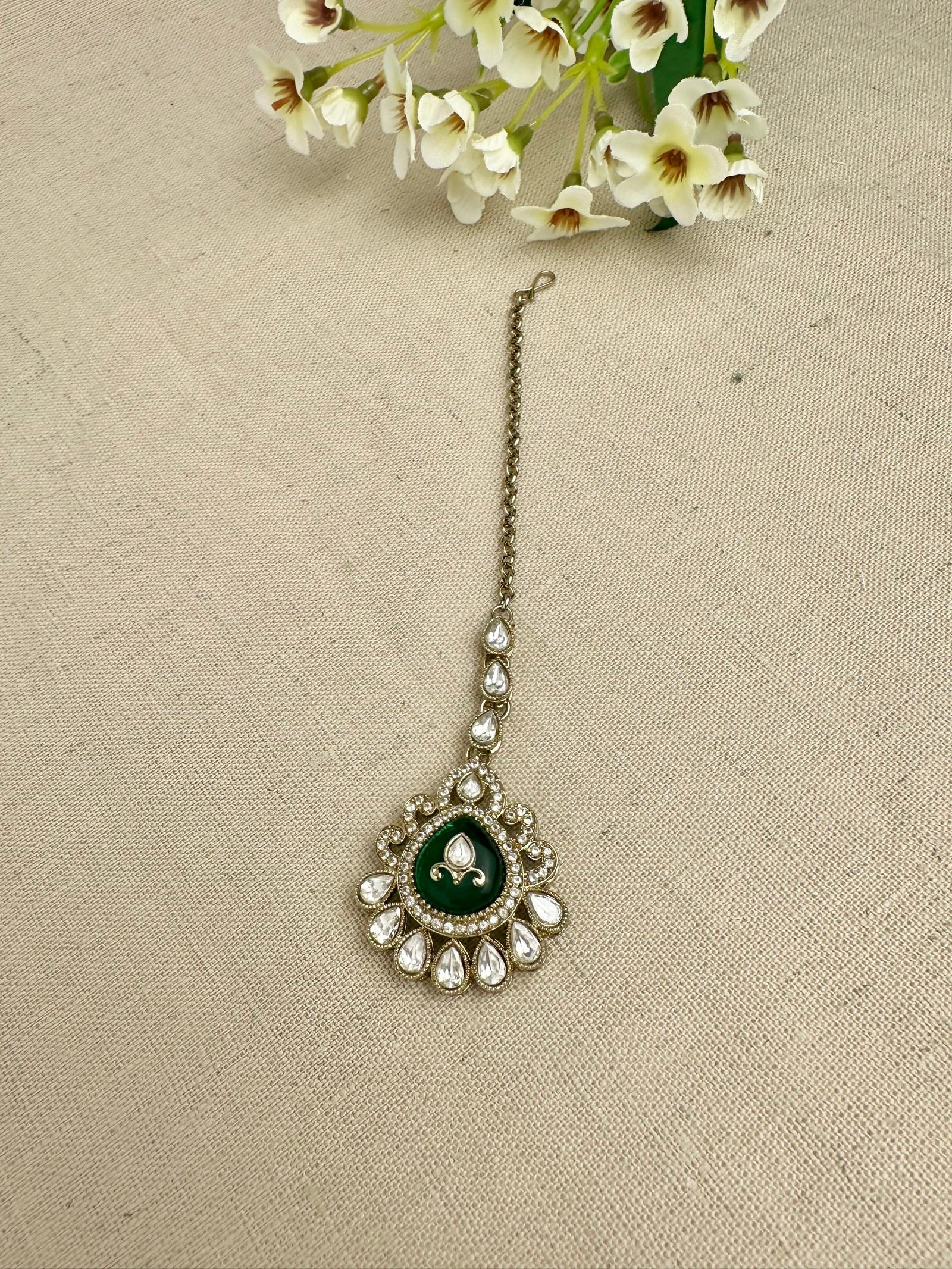 Close-up of matching kundan-style tikka from the Aarika choker set