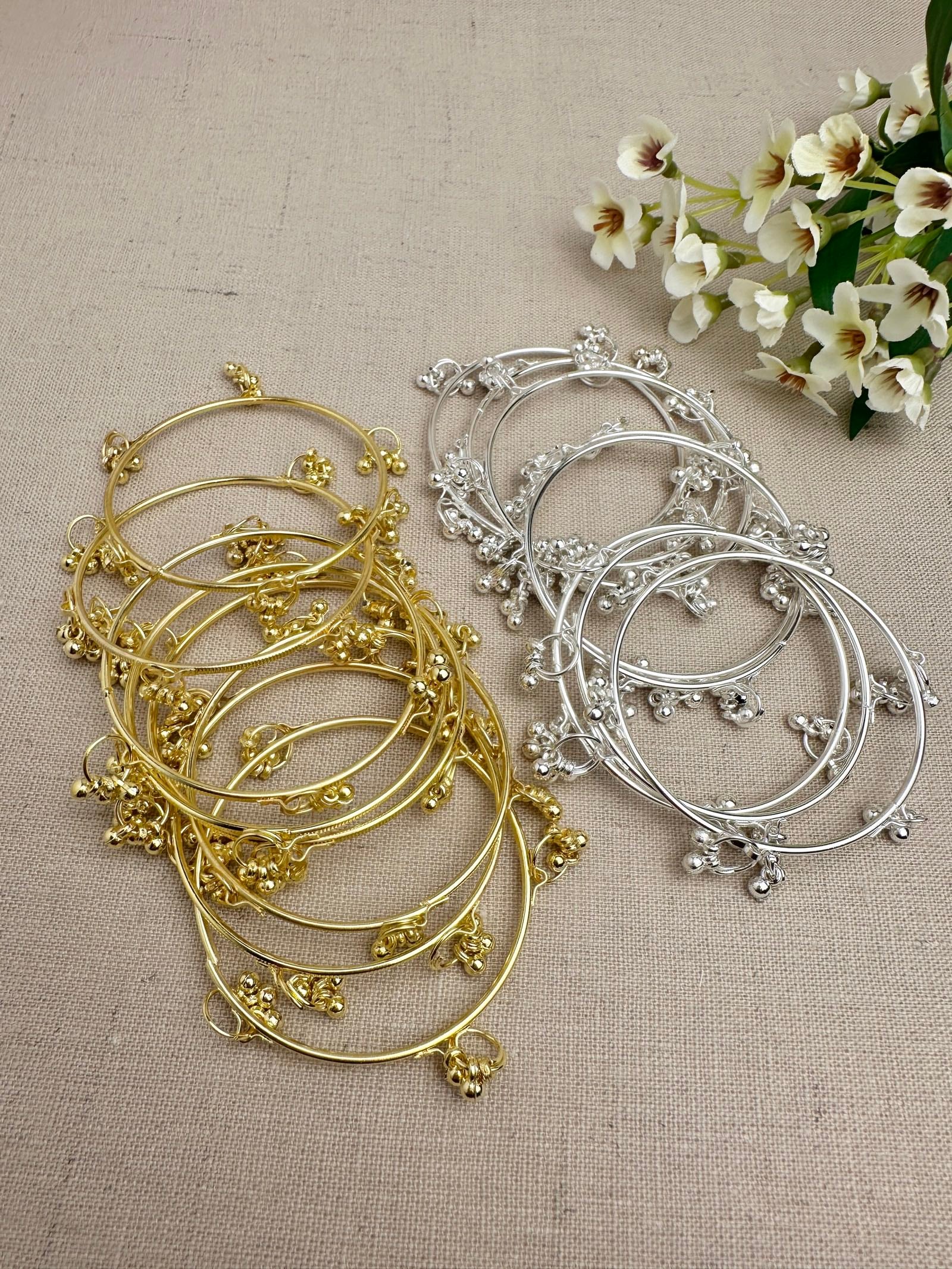 Gold and Silver Aarohi Kashmiri Ghungroo Bangles displayed flat to show the full design