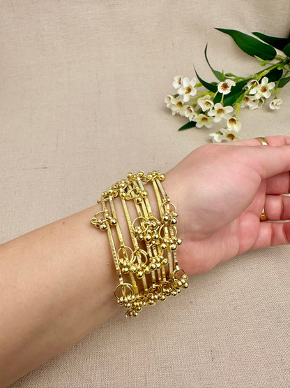 Gold Aarohi Kashmiri Ghungroo Bangles worn as a complete set of eight
