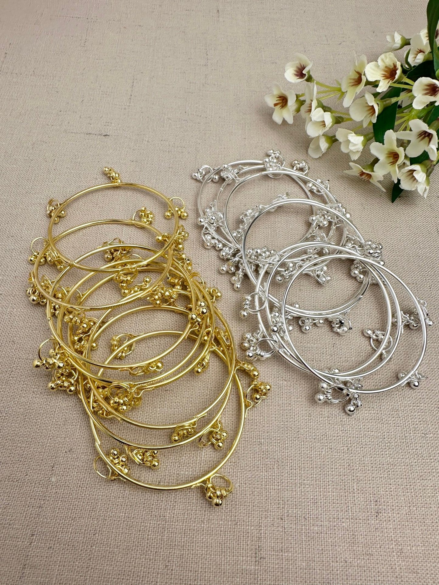 Gold and Silver Aarohi Kashmiri Ghungroo Bangles displayed flat to show the full design