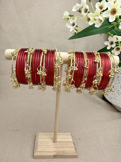 Aarohi Gold Ghungroo Bangles styled between red glass bangles for a layered festive look