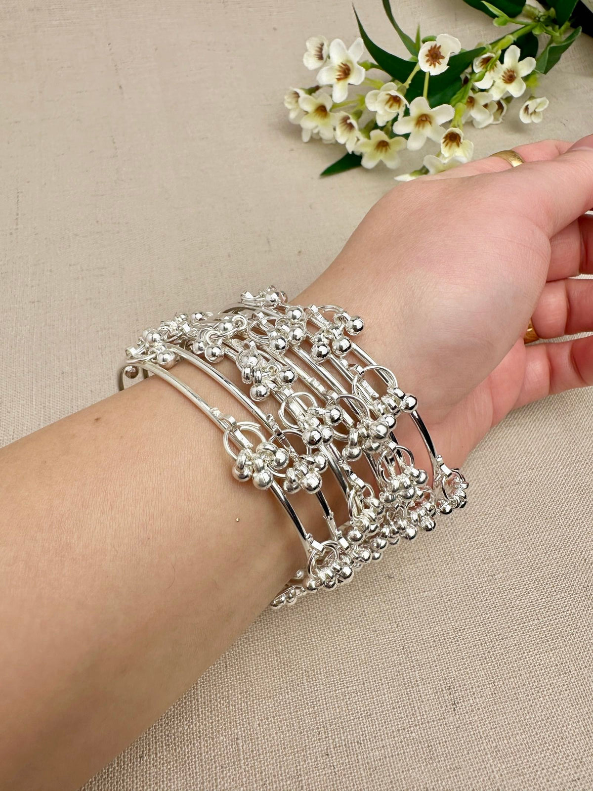 Silver Aarohi Kashmiri Ghungroo Bangles worn as a complete set of eight