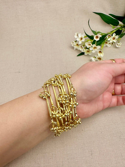Gold Aarohi Kashmiri Ghungroo Bangles worn as a complete set of eight
