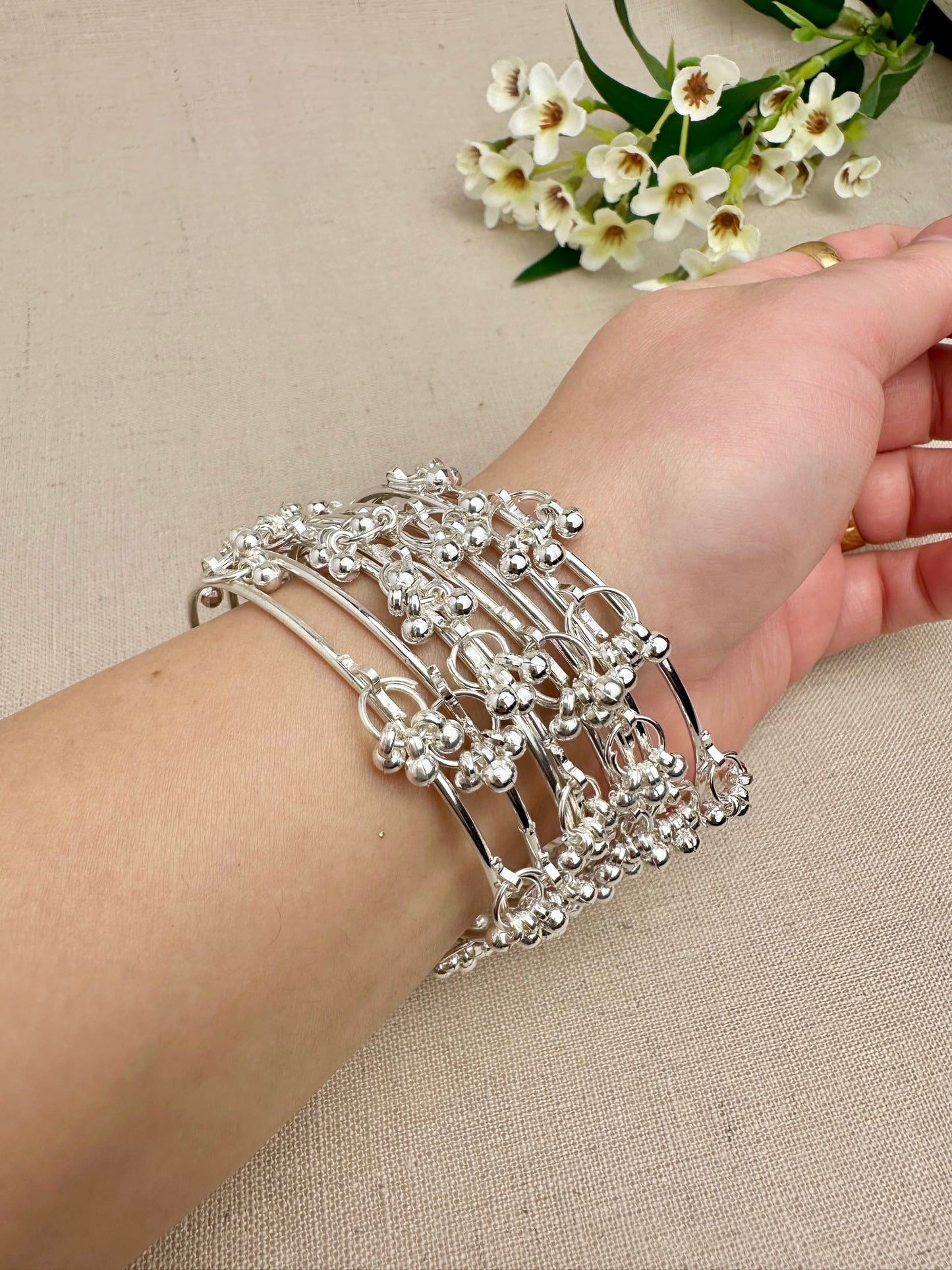 Silver Aarohi Kashmiri Ghungroo Bangles worn as a complete set of eight