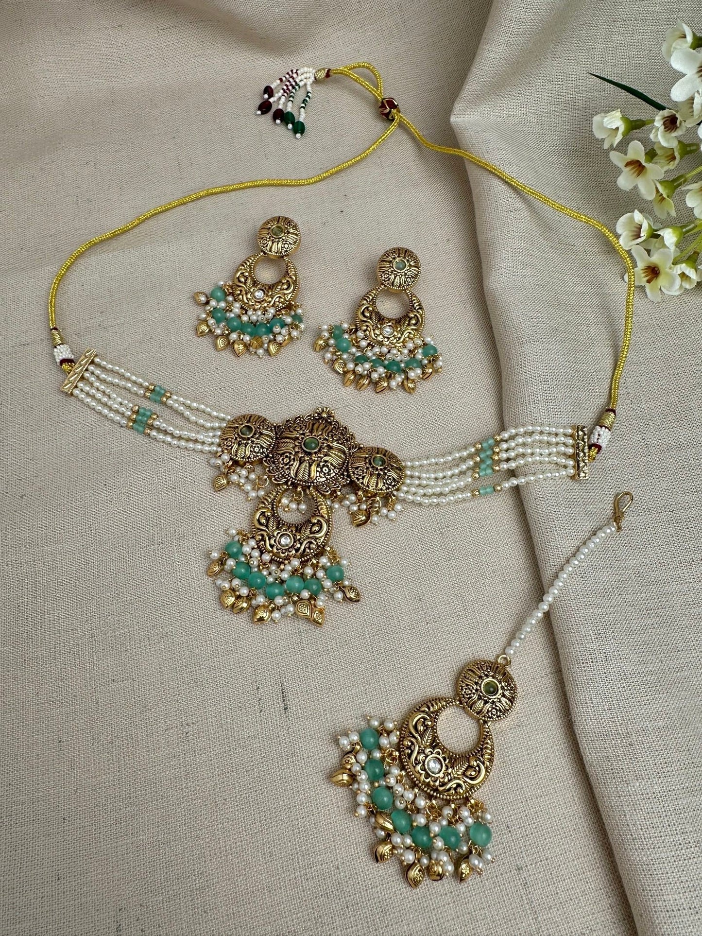     Aarohi antique gold pearl choker set in Mint Green with earrings and maang tikka