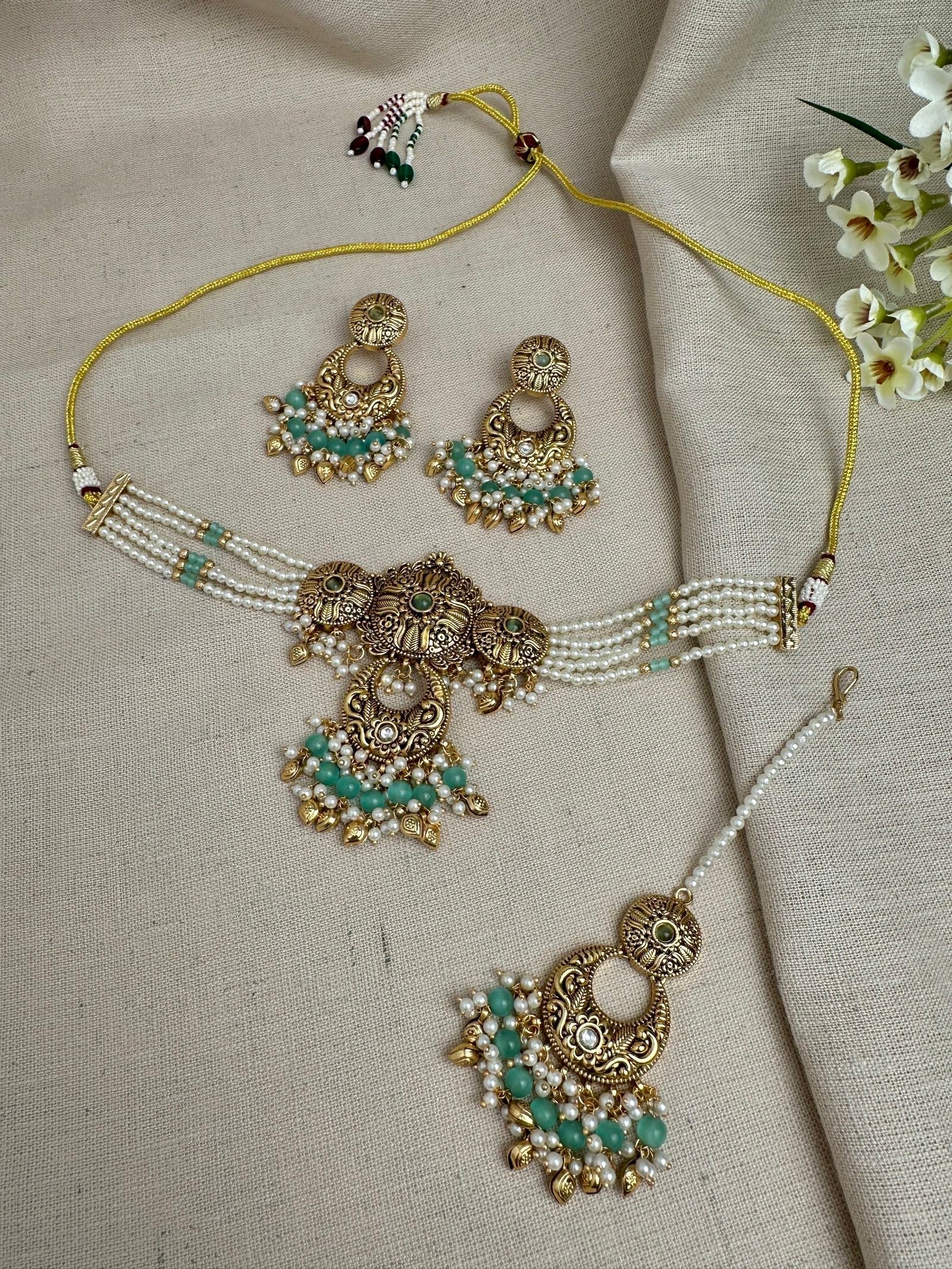     Aarohi antique gold pearl choker set in Mint Green with earrings and maang tikka