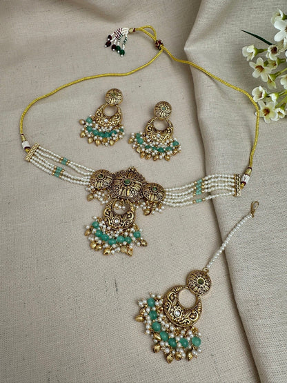     Aarohi antique gold pearl choker set in Mint Green with earrings and maang tikka