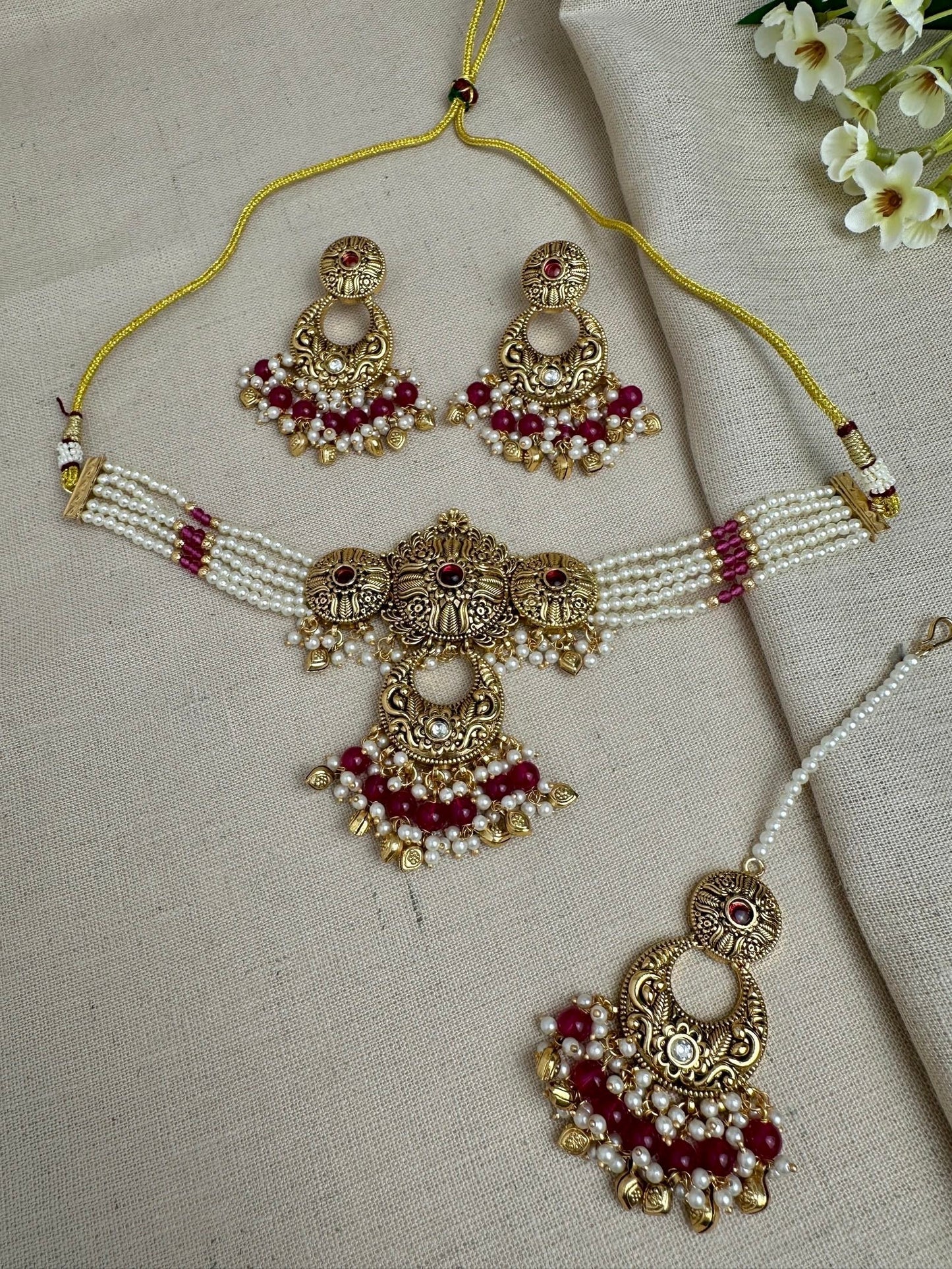     Aarohi antique gold pearl choker set in Ruby with earrings and maang tikka