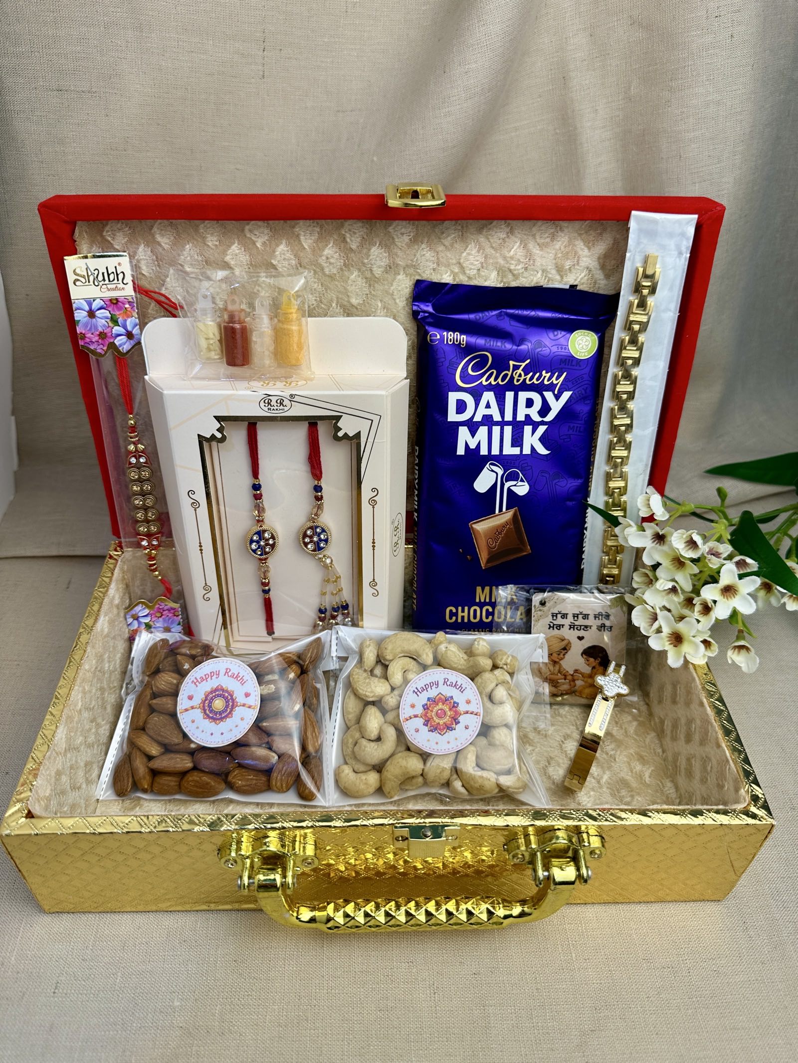 Open reusable Raksha Bandhan gift box showing all included gifts.