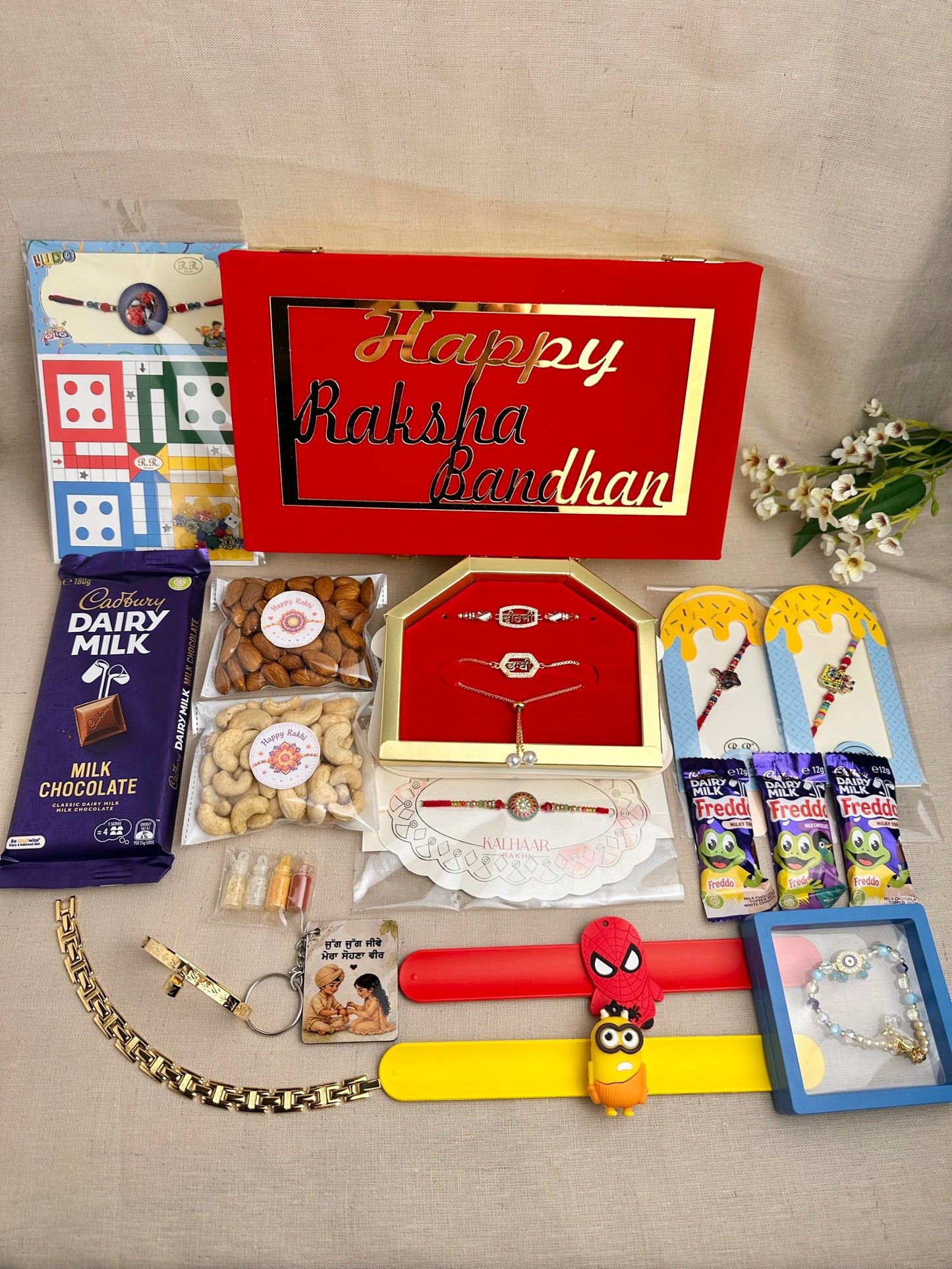 Complete Family Rakhi Gift Box with gifts for brother, bhabhi and children, chocolates, dry fruits, Ludo and reusable gift box.
