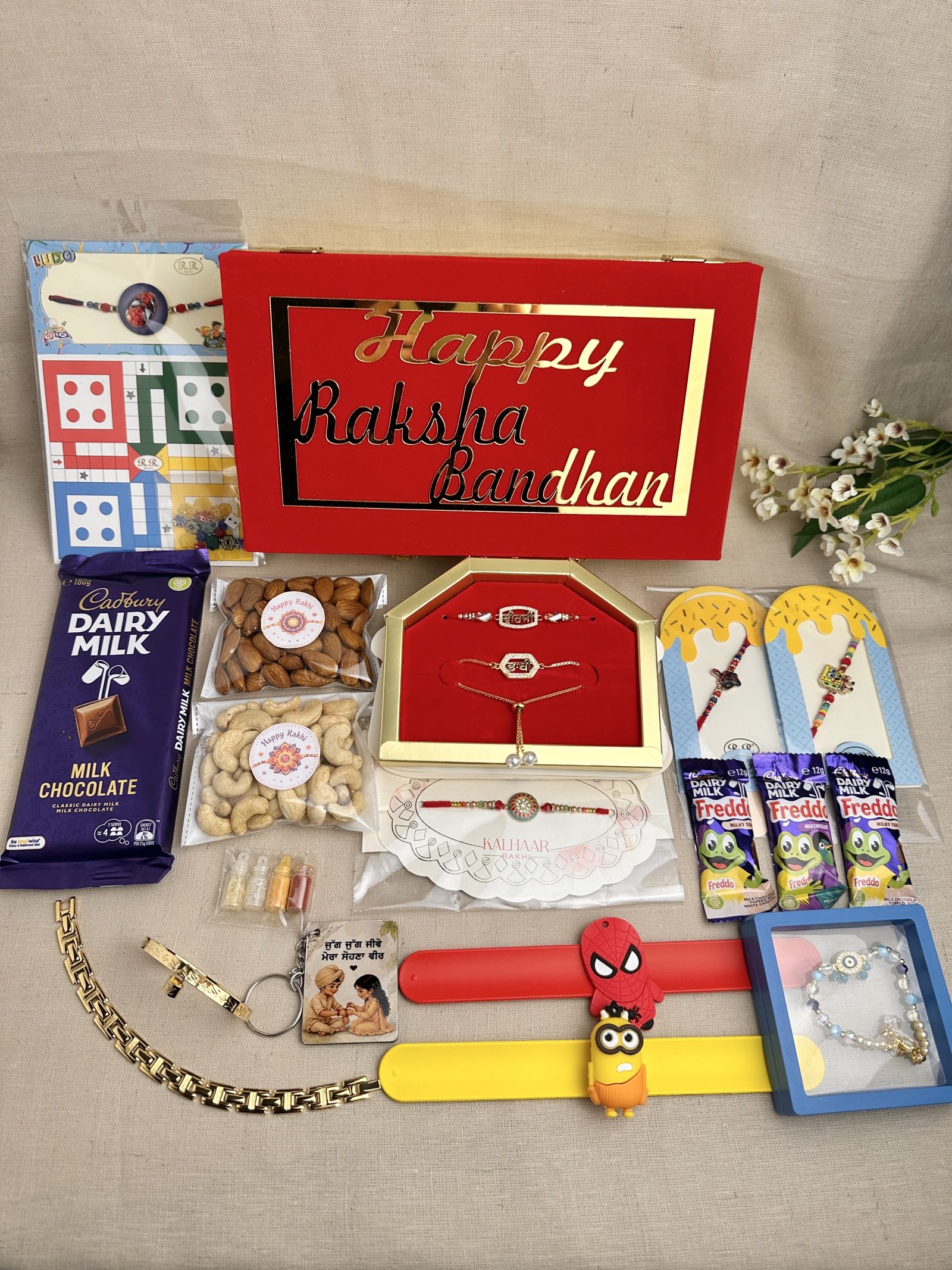 Complete Family Rakhi Gift Box with gifts for brother, bhabhi and children, chocolates, dry fruits, Ludo and reusable gift box.