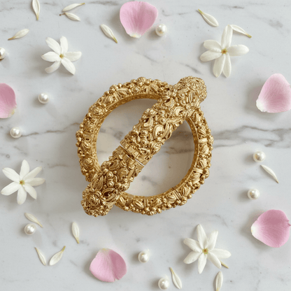 Dripti kangan set flat lay with flower petals and pearls on marble
