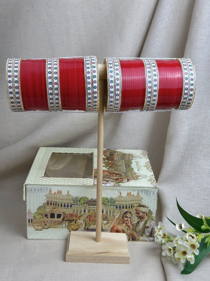 Red traditional Punjabi bridal chooda displayed with the included bridal box.