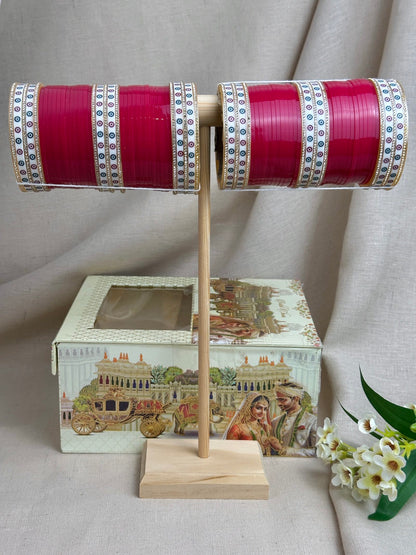 Hot pink traditional Punjabi bridal chooda displayed with the included bridal box.