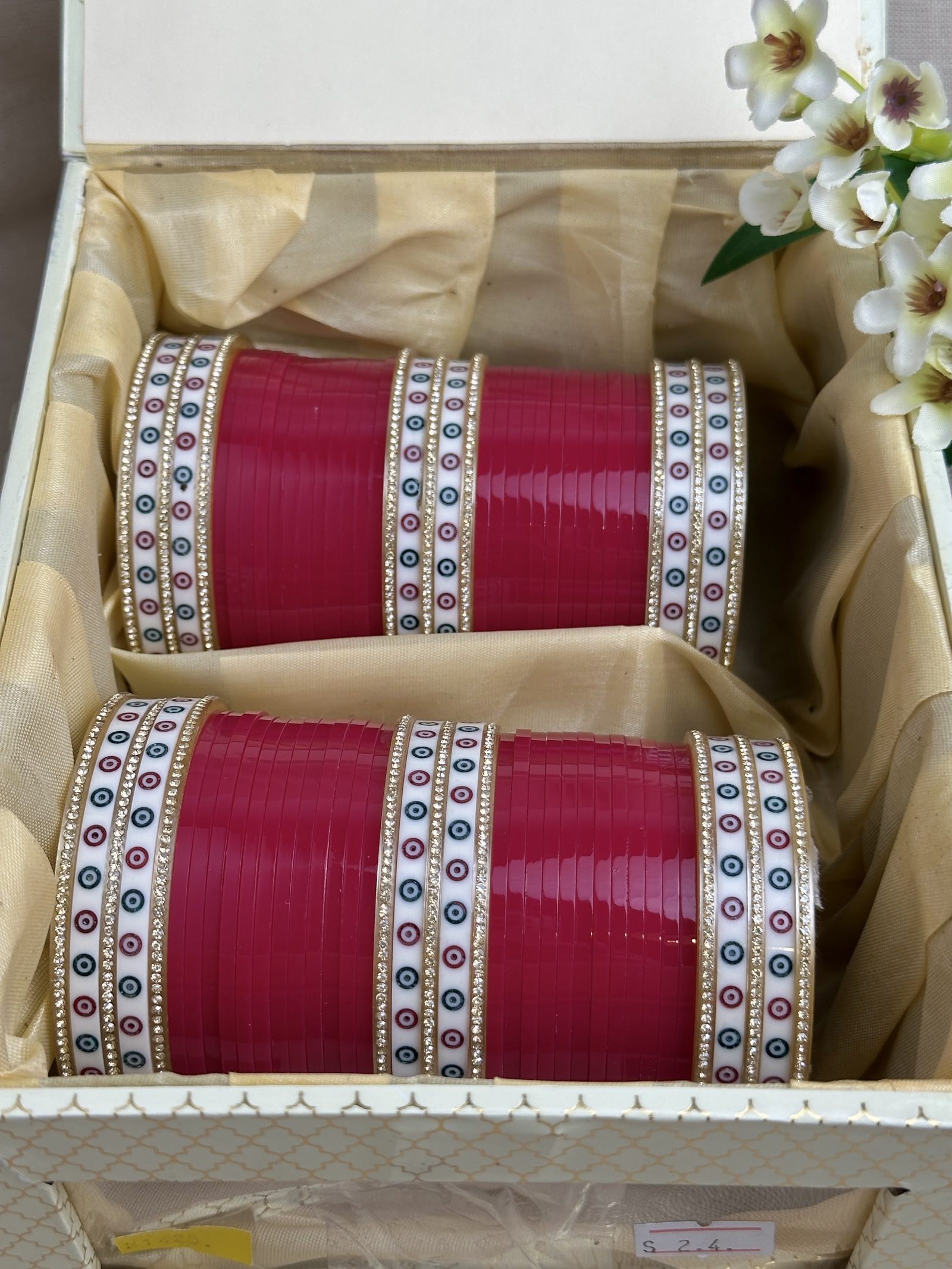 Complete hot pink Punjabi chooda set for both arms arranged inside the included bridal box.