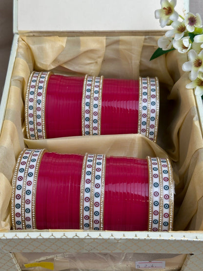 Complete hot pink Punjabi chooda set for both arms arranged inside the included bridal box.