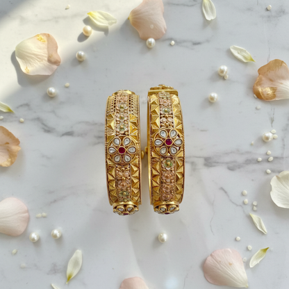 Dipasha kangan set flat lay with flower petals and pearls on marble