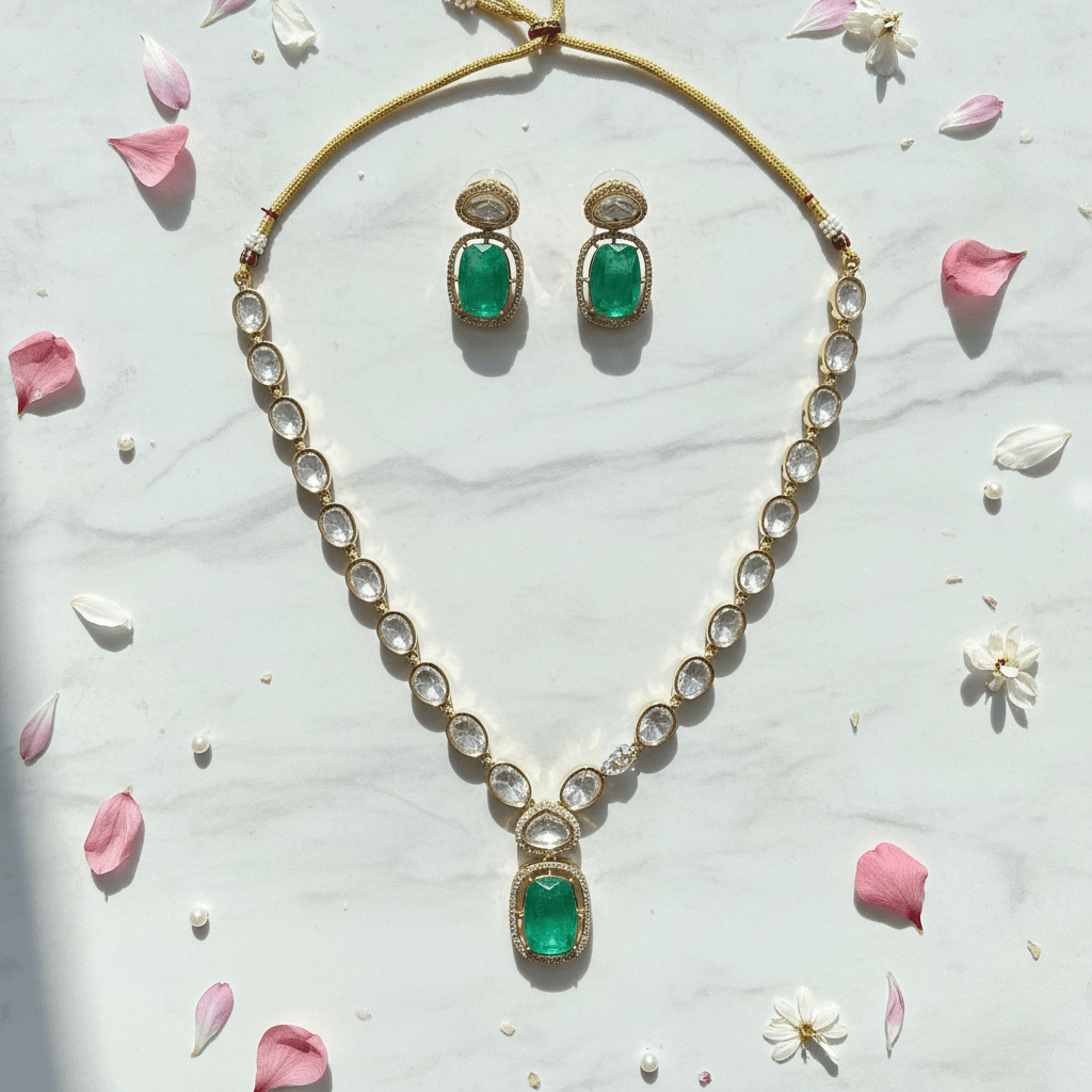 Jaya caret plated necklace set flat lay with flower petals and pearls on marble
