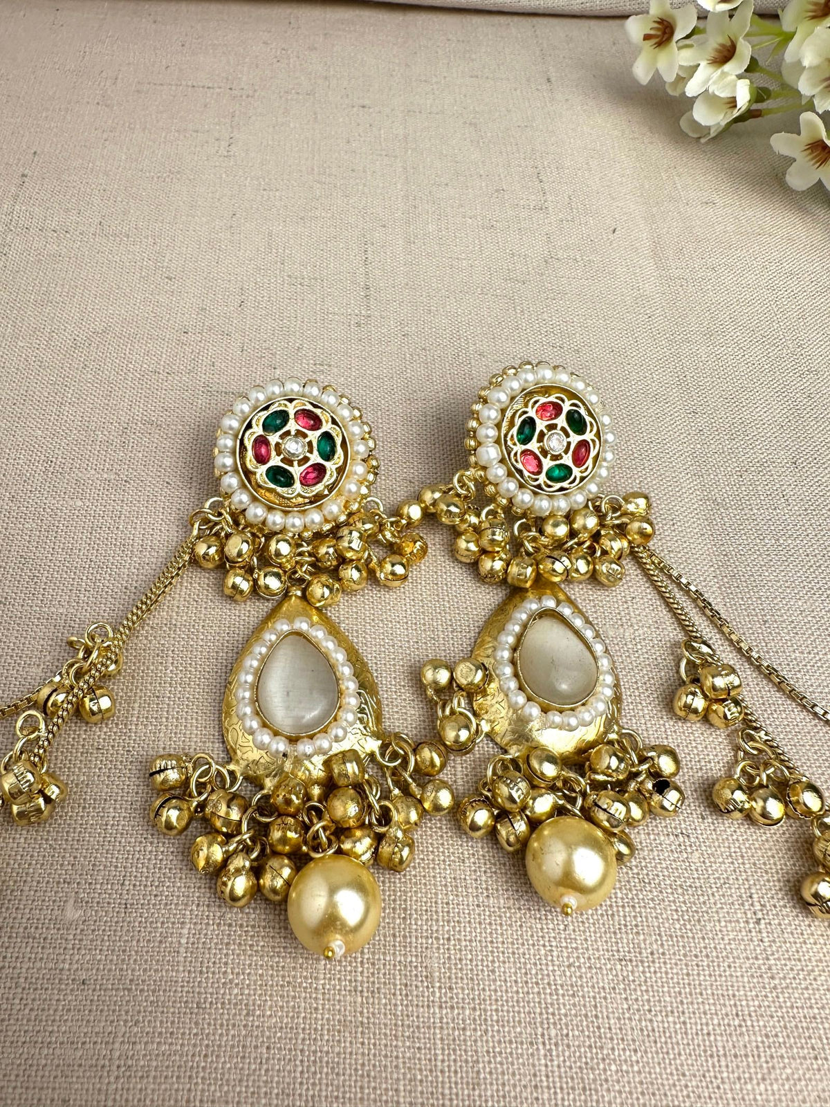     Close-up of Kanika Golden Pachi Kundan earrings with pearl and multicolour stone detailing