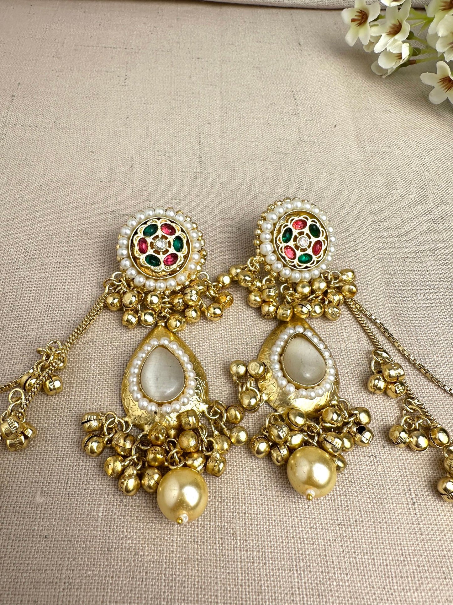     Close-up of Kanika Golden Pachi Kundan earrings with pearl and multicolour stone detailing