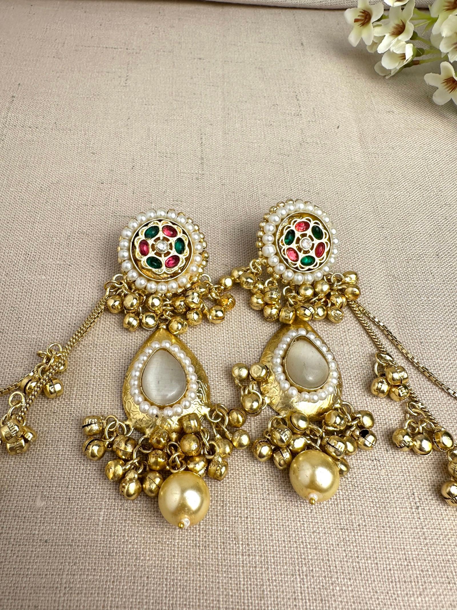     Close-up of Kanika Golden Pachi Kundan earrings with pearl and multicolour stone detailing