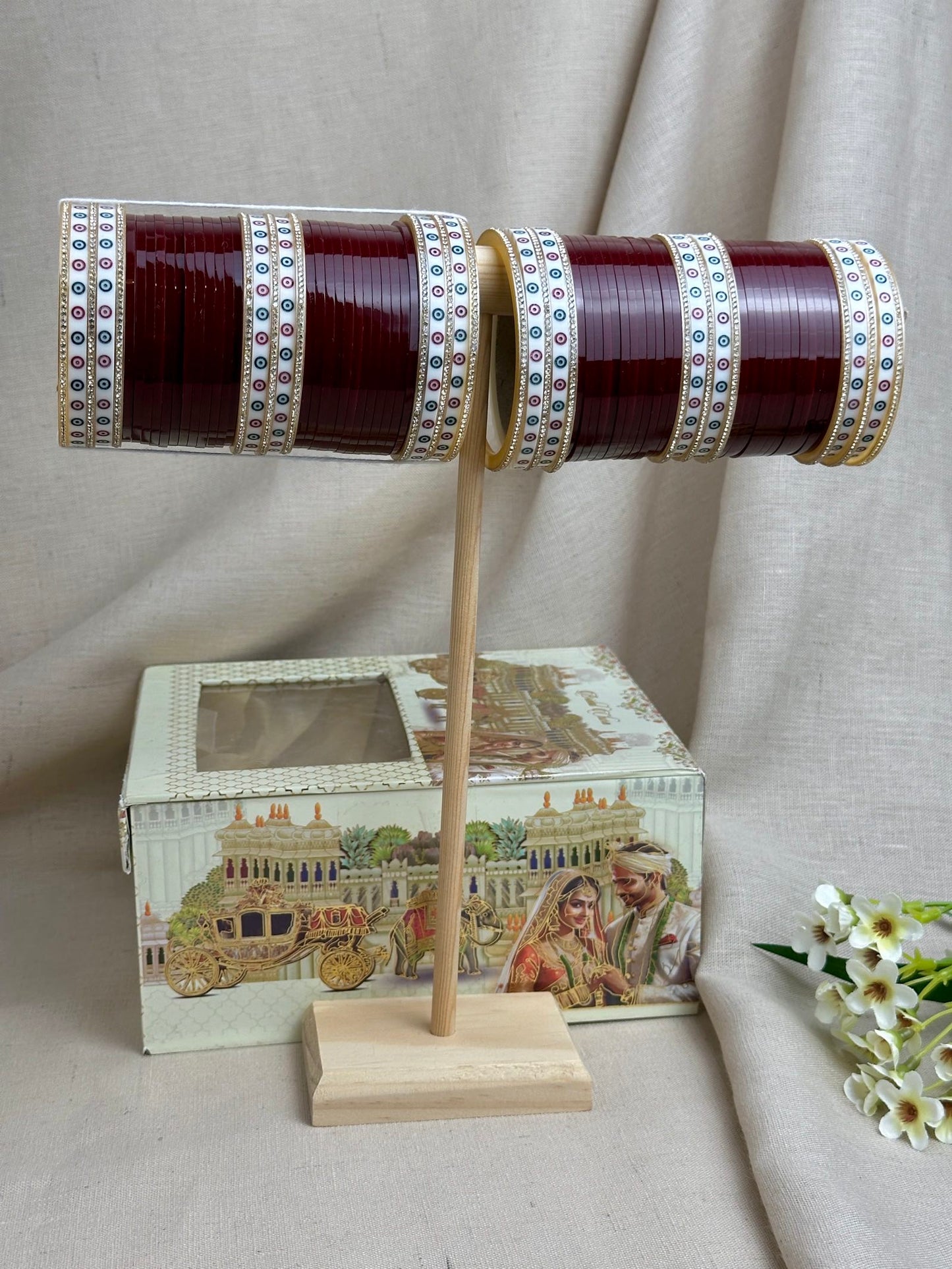 Maroon traditional Punjabi bridal chooda displayed with the included bridal box.