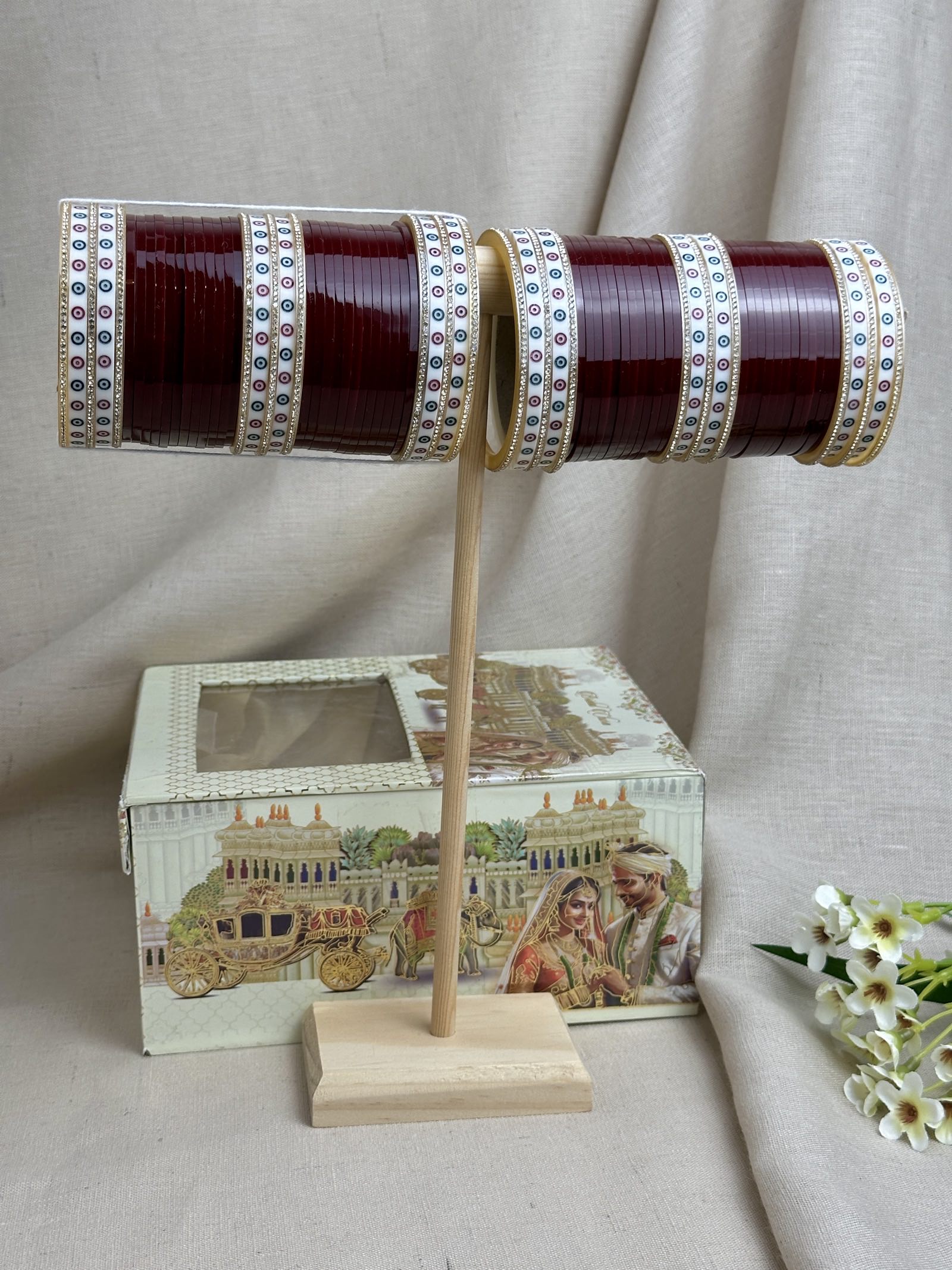 Maroon traditional Punjabi bridal chooda displayed with the included bridal box.