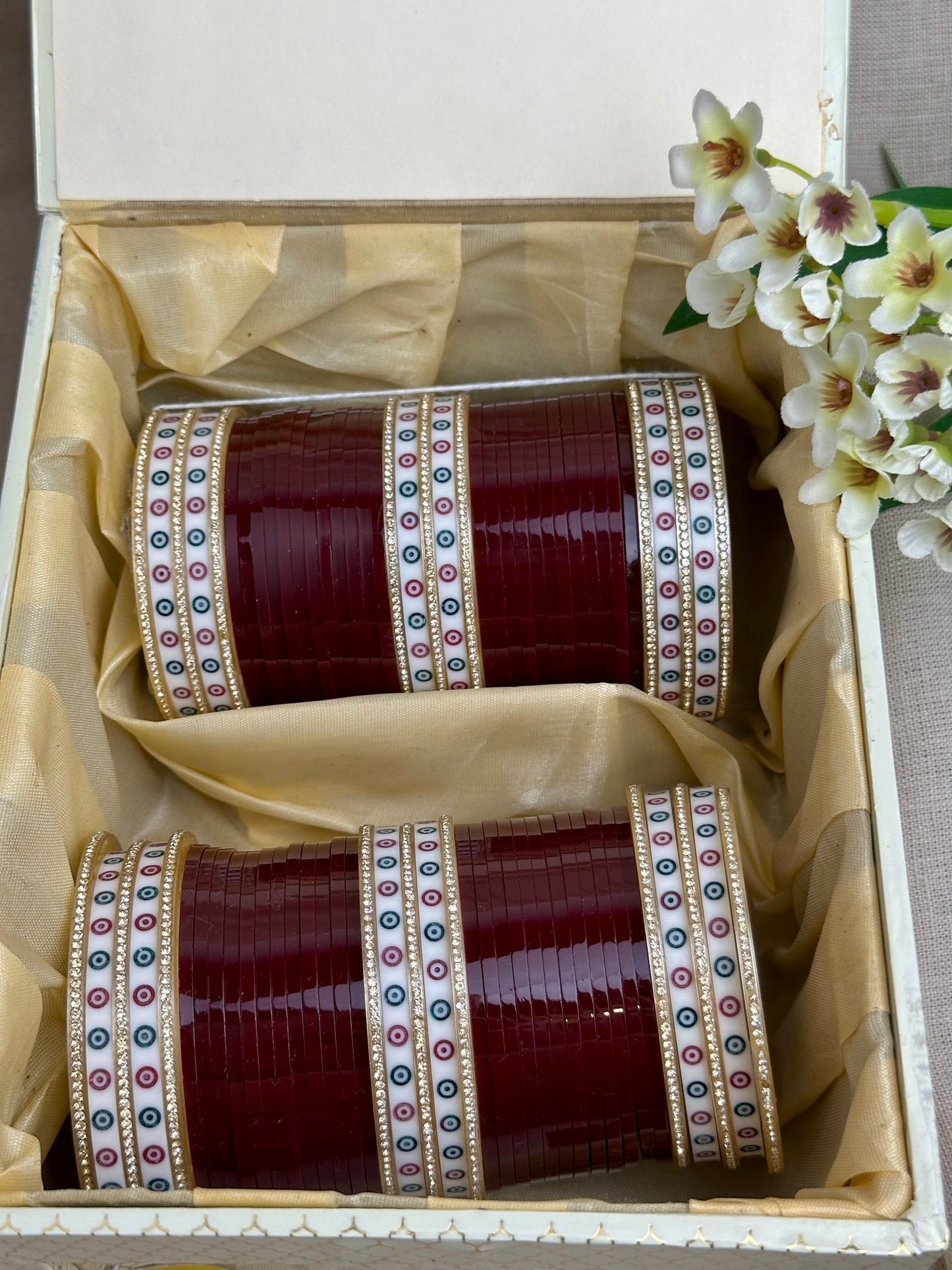 Complete maroon Punjabi chooda set for both arms arranged inside the included bridal box.