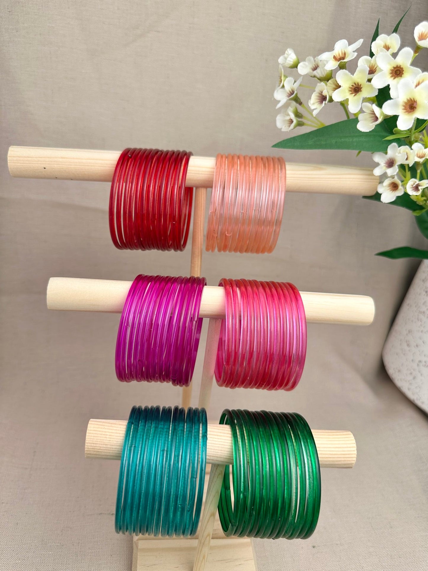 Mayra Jelly Glass Bangles in Red, Peach, Magenta, Ruby, Teal and Green displayed as one-dozen sets