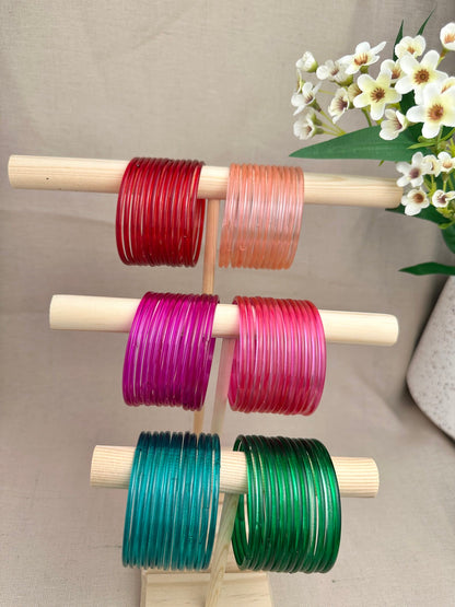Mayra Jelly Glass Bangles in Red, Peach, Magenta, Ruby, Teal and Green displayed as one-dozen sets