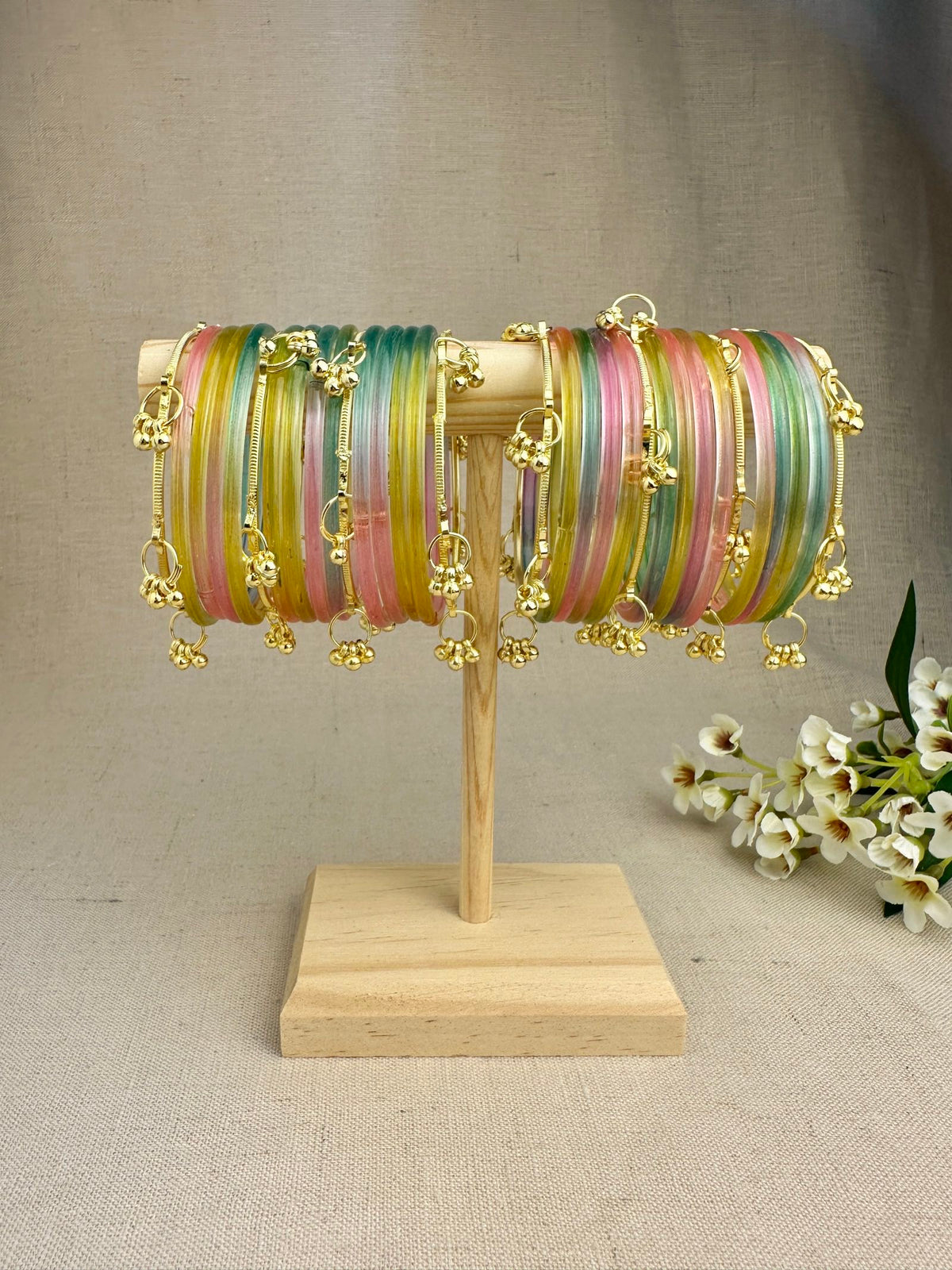 Mayra Pastel Multicolor Jelly Bangles styled with gold-tone bangles featuring dangling ghungroo latkans.