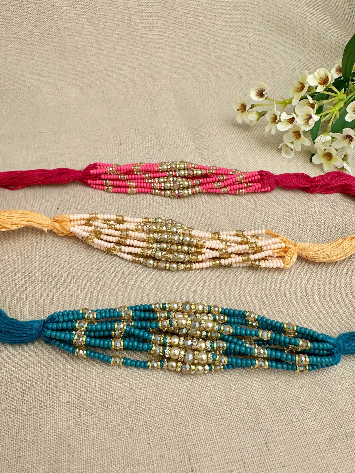 Design 1 premium pearl and crystal Rakhi dhagas in assorted pink, cream and teal colours