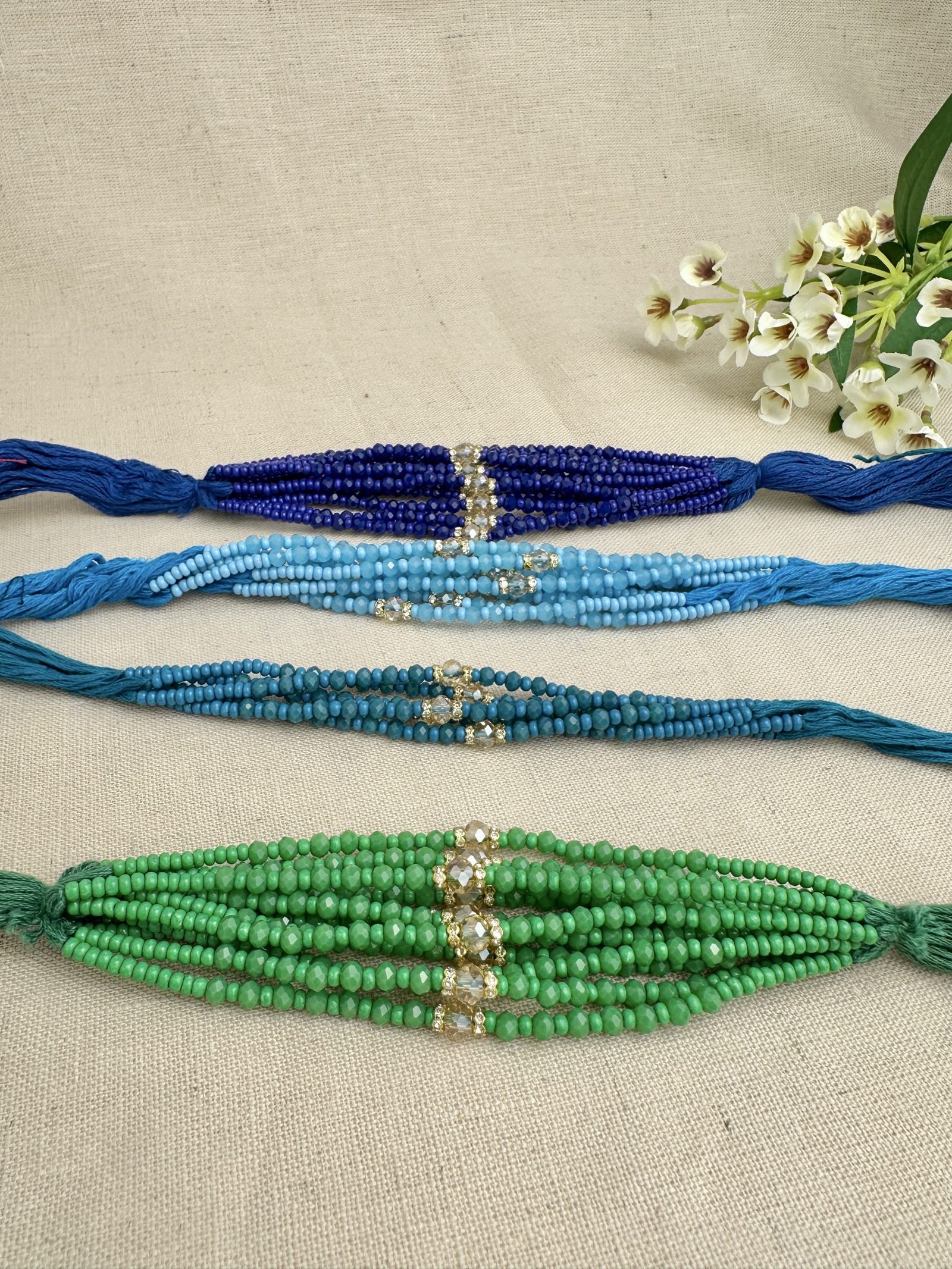 Design 2 single-crystal Rakhi dhagas in assorted blue and green colours