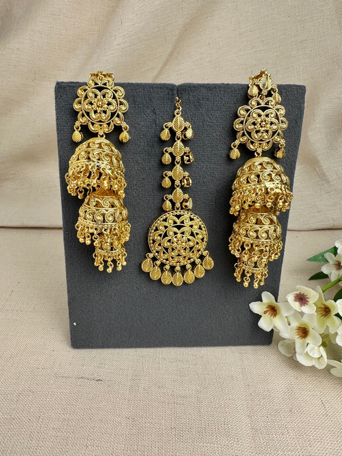 Noor gold-plated Punjabi triple jhumki earrings and medium tikka set in bright yellow gold