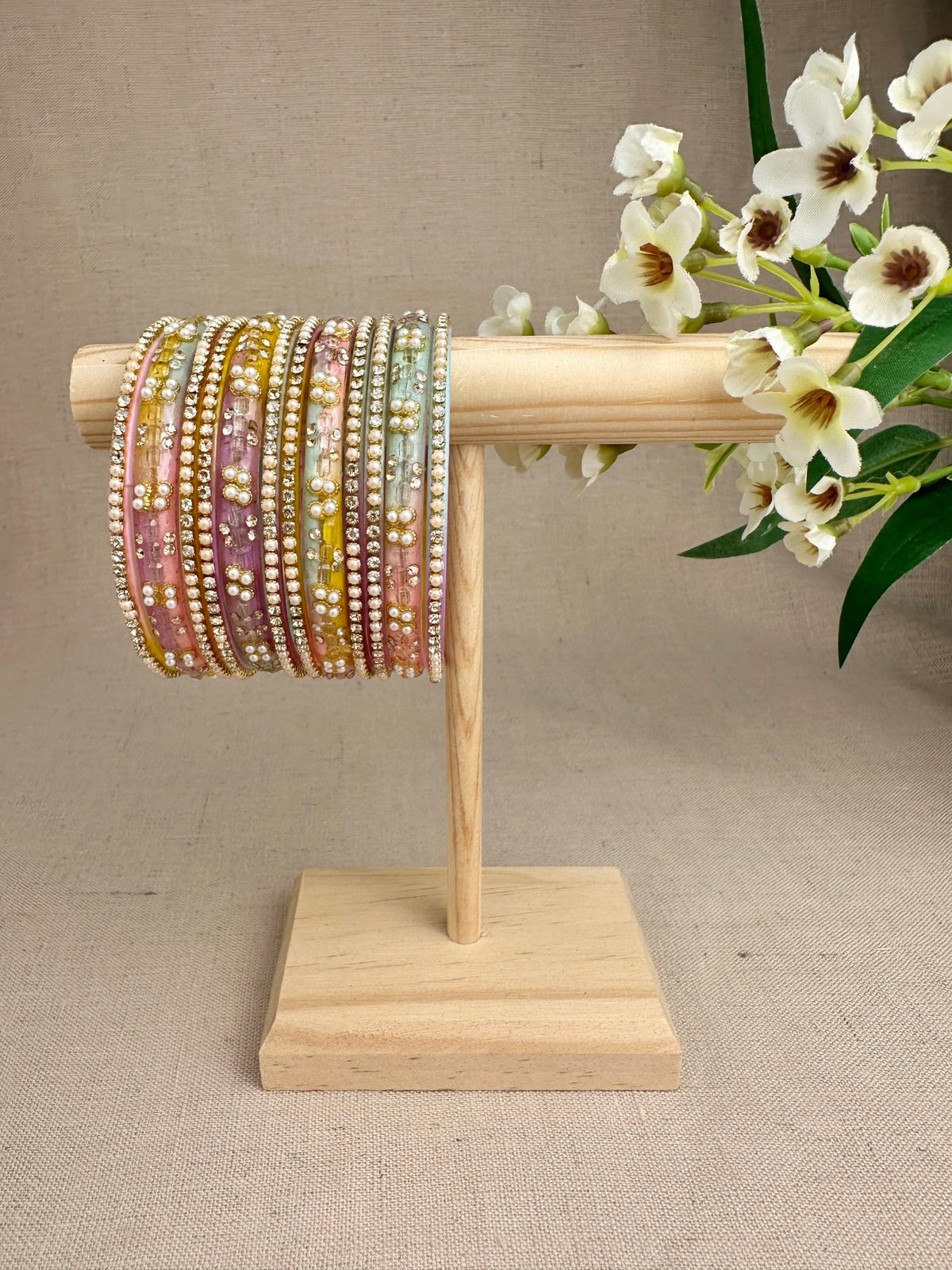 Noor Pastel Multi glass bangles set of 12 featuring soft pastel colours, pearl accents and sparkling stone detailing.
