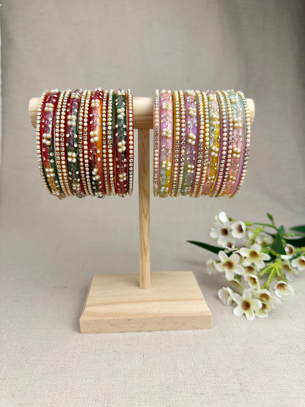 Noor Multicolour Glass Bangles displayed in Pastel Multi and Dark Multi, featuring decorative glass bangles and matching thin stone-studded bangles.
