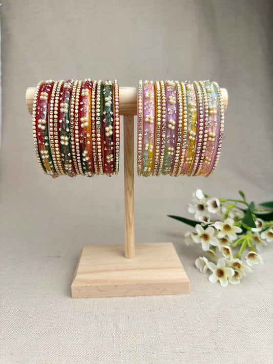 Noor Multicolour Glass Bangles displayed in Pastel Multi and Dark Multi, featuring decorative glass bangles and matching thin stone-studded bangles.