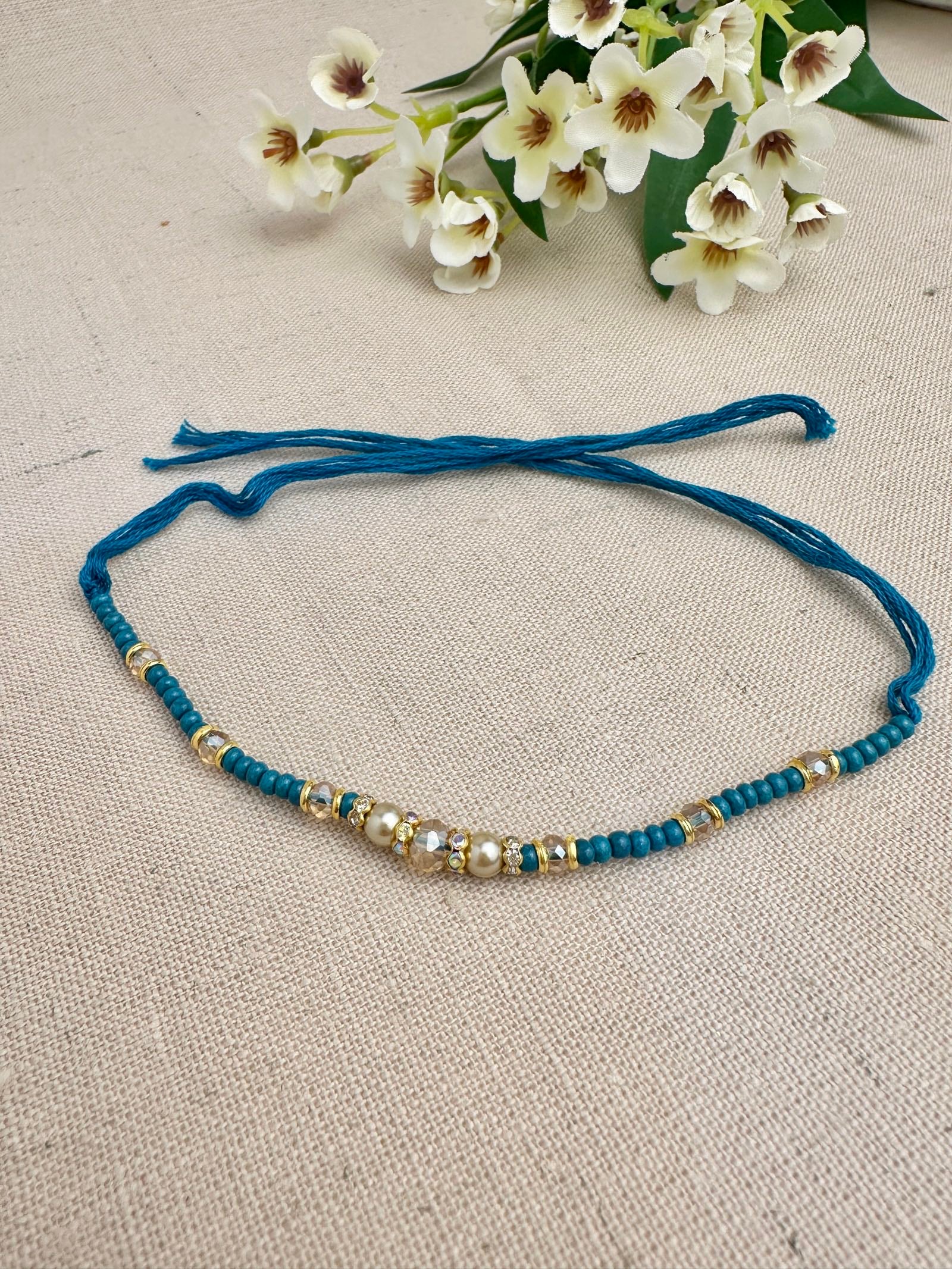Noor Design 1 premium teal Rakhi dhaga with pearls, crystals and gold-toned details