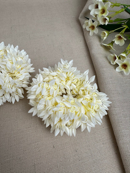 Close-up of an off-white artificial gajra with small bud-like detailing.