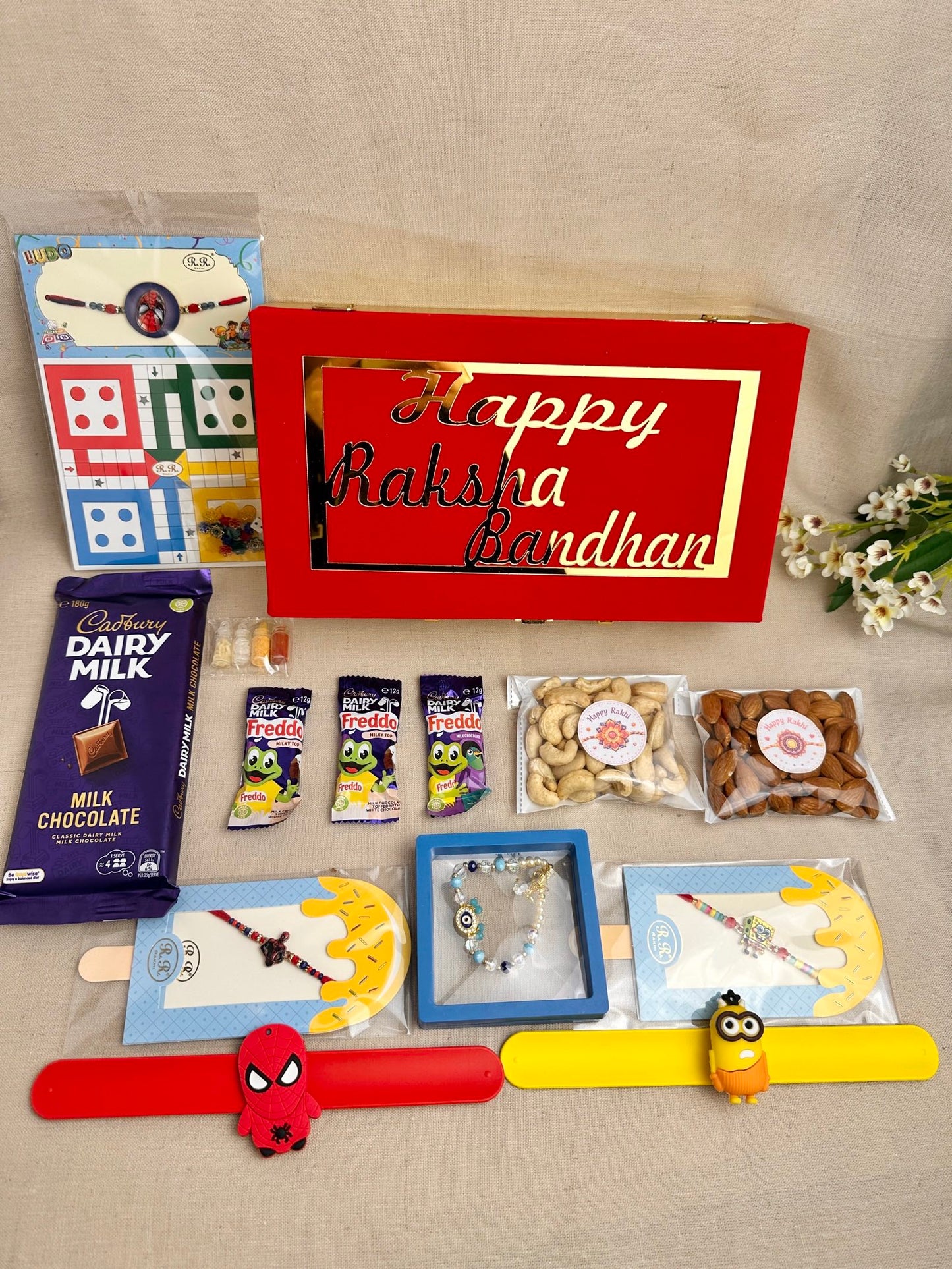 Rakhi Gift Box for 3 children with age-appropriate Rakhis, chocolates, dry fruits and gifts.