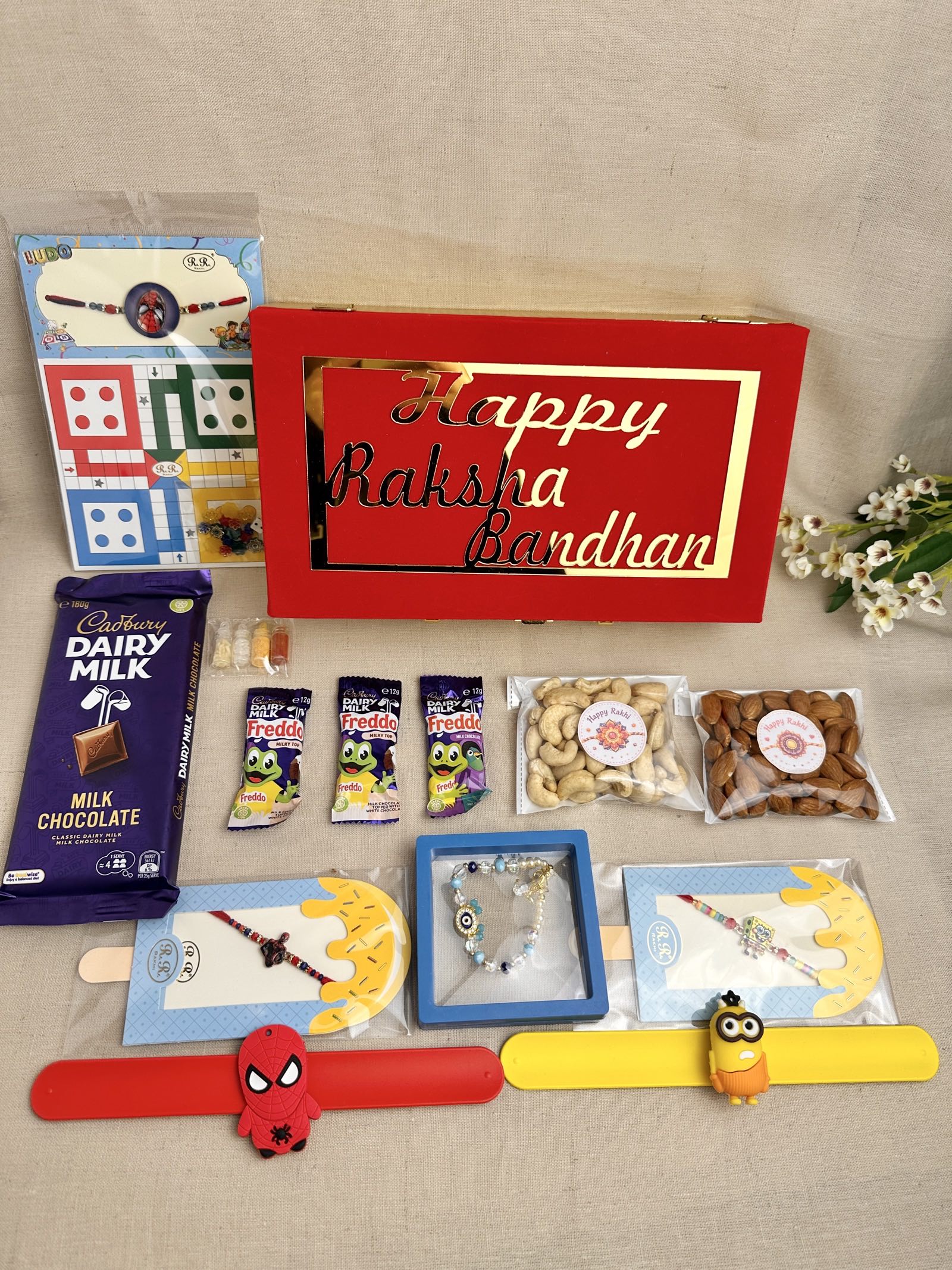 Rakhi Gift Box for 3 children with age-appropriate Rakhis, chocolates, dry fruits and gifts.
