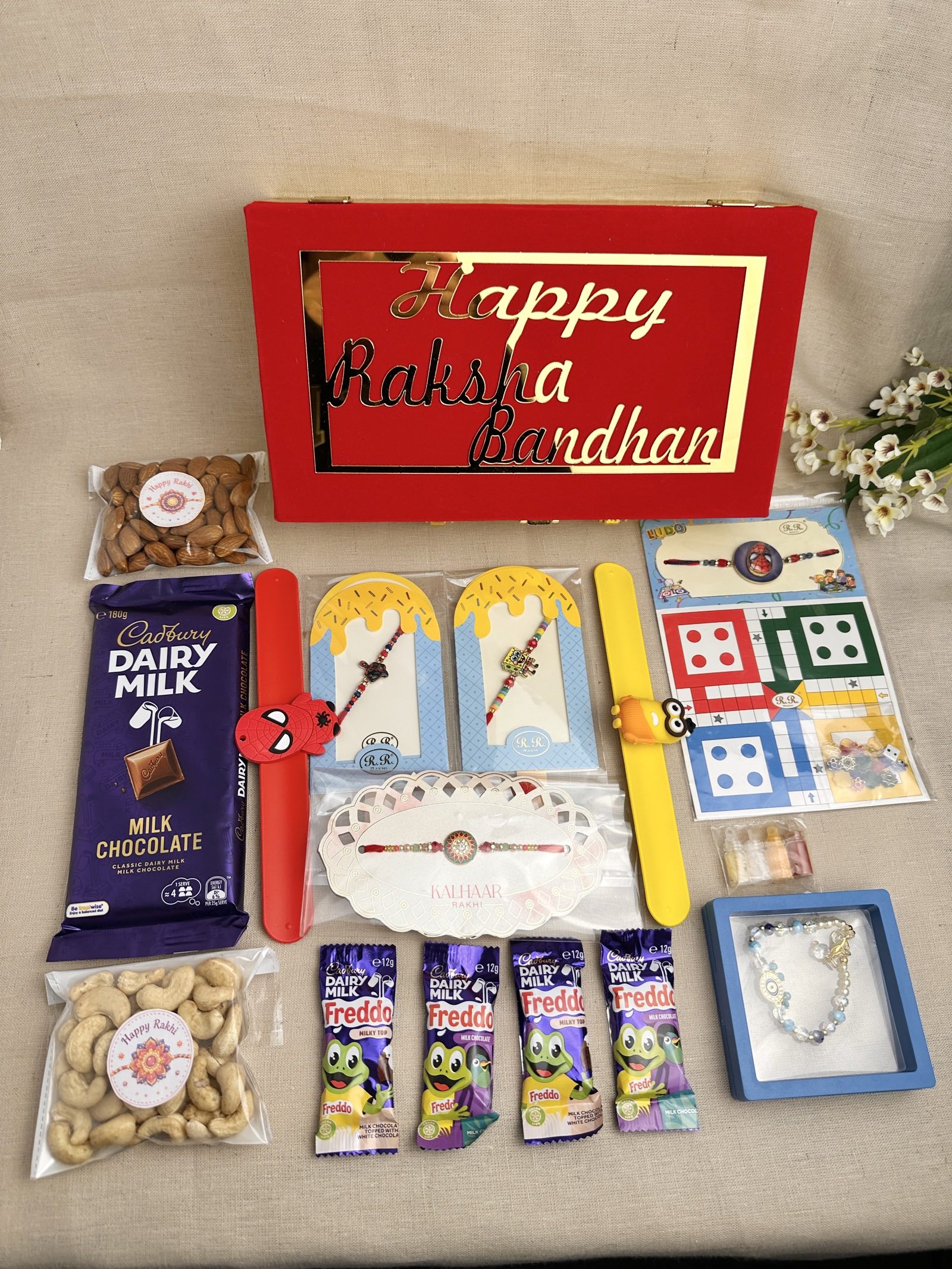 Rakhi Gift Box for 4 children with age-appropriate Rakhis, chocolates, dry fruits and festive gifts.