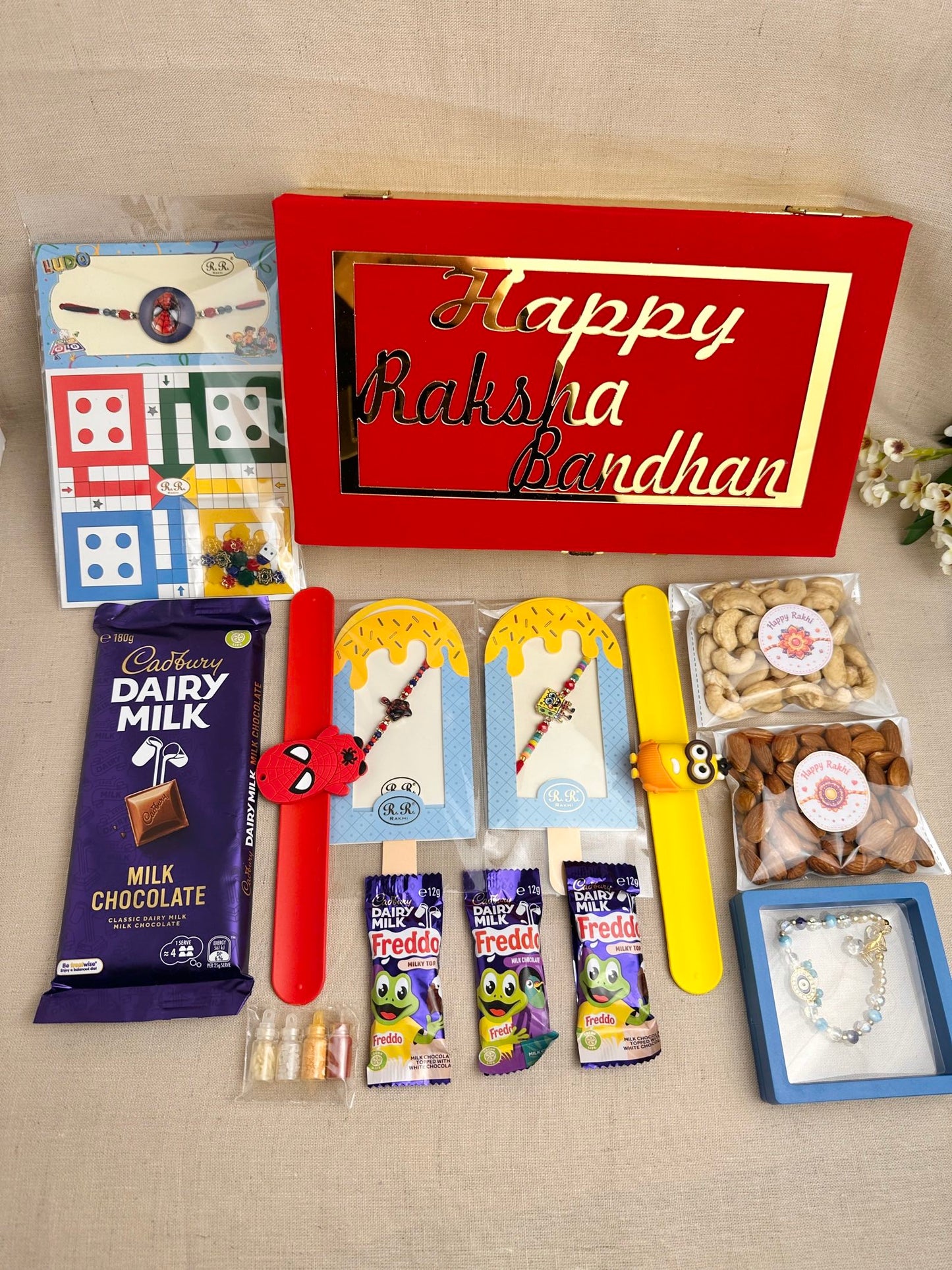 Rakhi Gift Box for multiple kids with age-appropriate Rakhis, chocolates, dry fruits and gifts.