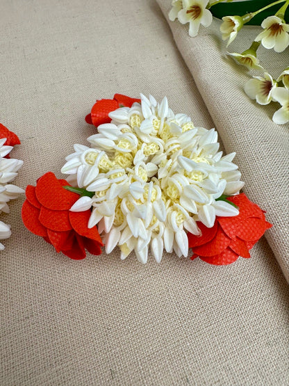 Close-up of red and off-white artificial gajras with small bud-like detailing.
