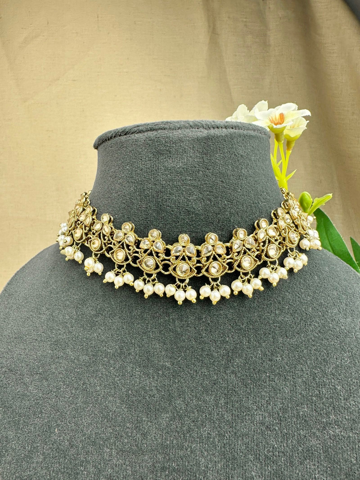 Close-up of Saanjh champagne stone choker with pearl-style drops
