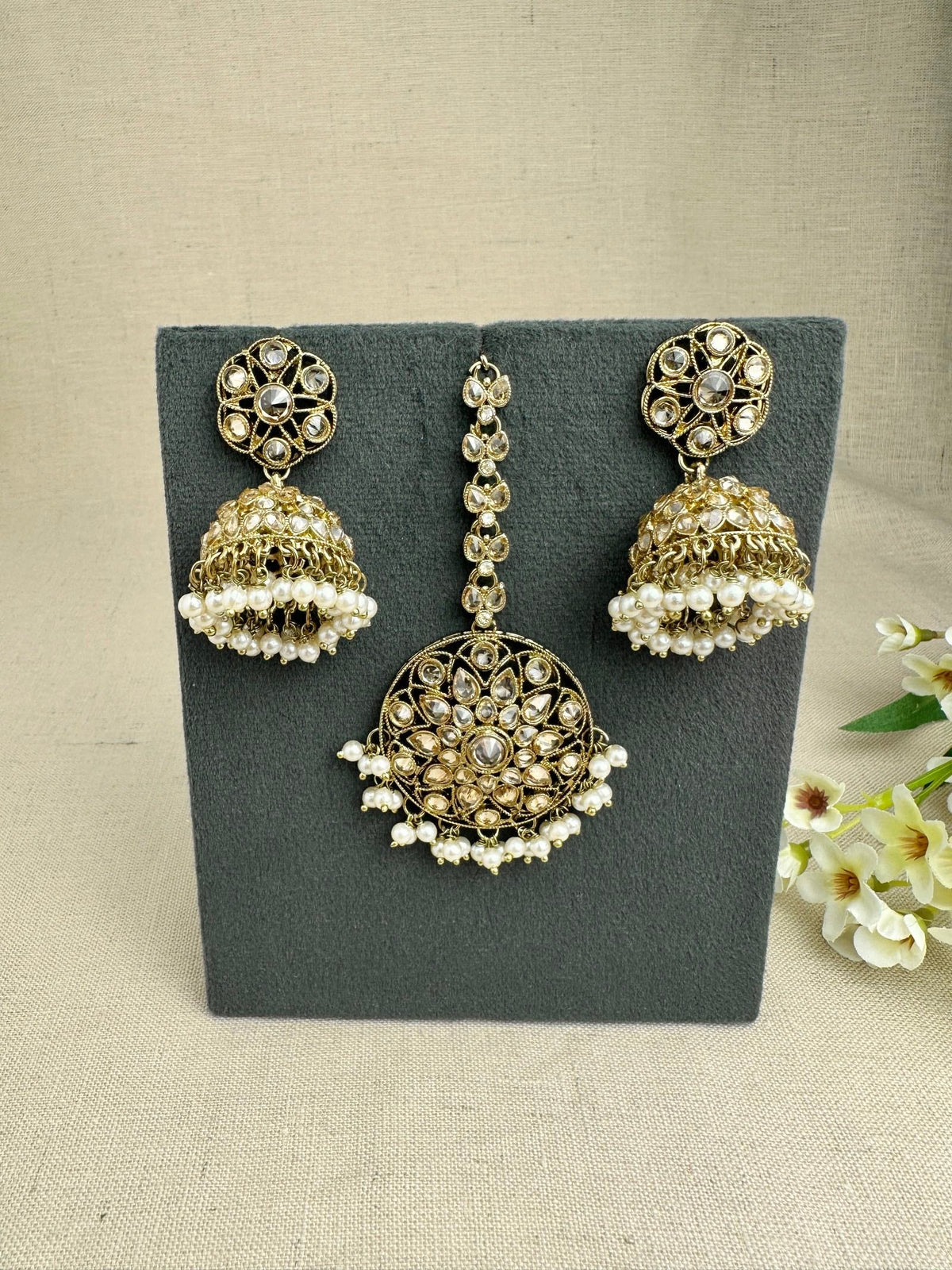 Matching champagne jhumkis and tikka from the Saanjh necklace set
