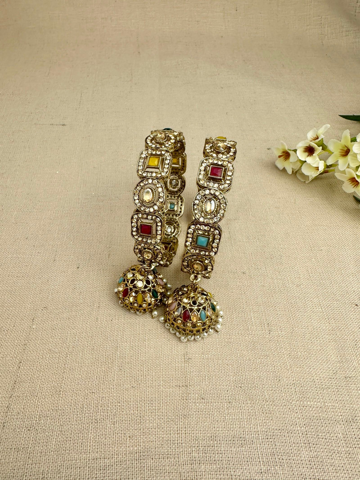 Close view of Saanjh Multicolour kangans with pearl detailing and jhumkis